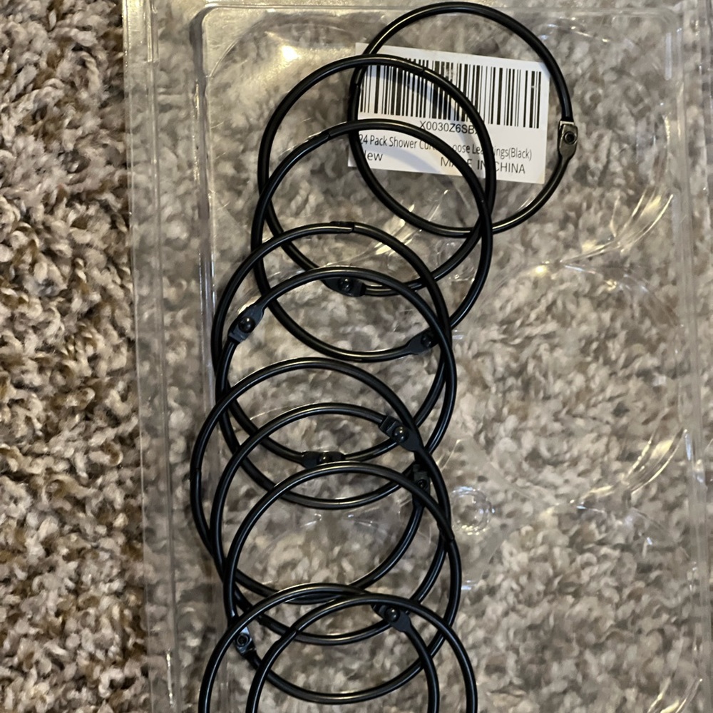 Nine black shower rings
